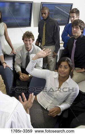 Group of young workers in office gathered for a meeting View Large Photo Image Stock Photo - Group of young workers in office gathered for a meeting. Fotosearch