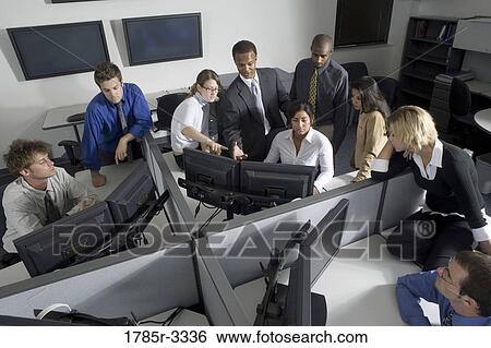 Group of young workers in office working on computers View Large Photo Image Stock Photograph - Group of young workers in office working on computers. Fotosearch