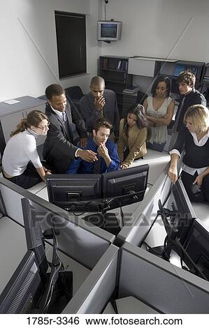Group of young workers in office gathered around computer screen View Large Photo Image Stock Photograph - Group of young workers in office gathered around computer screen. Fotosearch