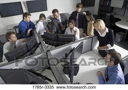 Group of young workers in office working on computers View Large Photo Image Stock Photography - Group of young workers in office working on computers. Fotosearch