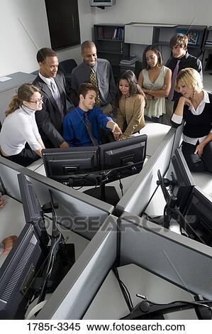 Group of young workers in office gathered around computer screen View Large Photo Image Stock Photography - Group of young workers in office gathered around computer screen. Fotosearch