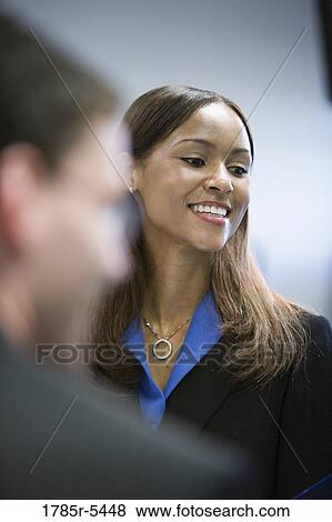Head-shot of a business woman with colleague in foreground View Large Photo Image Stock Photo - Head-shot of a business woman with colleague in foreground. Fotosearch