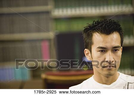 Stock Photography - Head shot of a contemplative young man. Fotosearch
