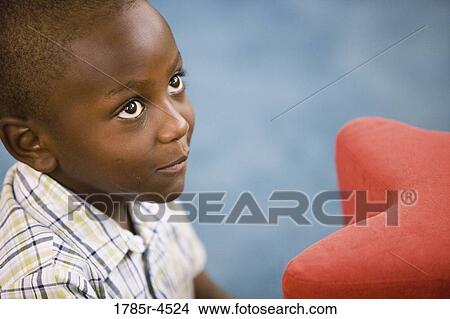 Head-shot of a young boy in a colorful room View Large Photo Image Picture - Head-shot of a young boy in a colorful room. Fotosearch