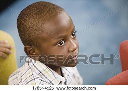 Head-shot of a young boy in a colorful room View Large Photo Image Stock Photography - Head-shot of a young boy in a colorful room. Fotosearch