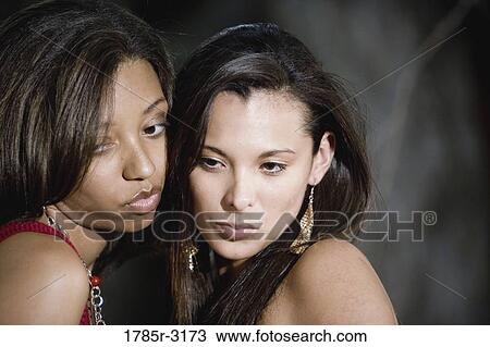 Head-shot of two young women looking down View Large Photo Image Stock Image - Head-shot of two young women looking down. Fotosearch