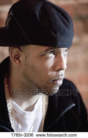 Head-shot of young man in hip-hop fashion looking away View Large Photo Image Stock Photograph - Head-shot of young man in hip-hop fashion looking away. Fotosearch