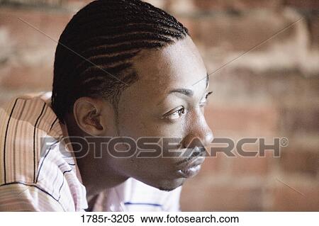 Head-shot of young man with corn rows looking away View Large Photo Image Stock Photography - Head-shot of young man with corn rows looking away. Fotosearch