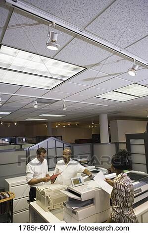 High angle view of a office colleagues using office equpment View Large Photo Image Stock Image - High angle view of a office colleagues using office equpment. Fotosearch