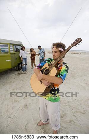 Hippies at the beach with guitar View Large Photo Image Stock Image - Hippies at the beach with guitar. Fotosearch