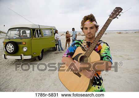 Hippies at the beach with guitar View Large Photo Image Stock Image - Hippies at the beach with guitar. Fotosearch