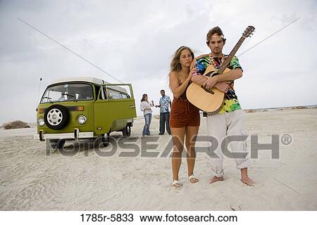 Hippies at the beach with guitar View Large Photo Image Stock Image - Hippies at the beach with guitar. Fotosearch