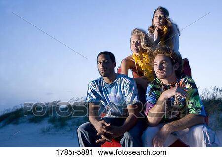 Hippies hanging out at the beach on lifeguard chair View Large Photo Image Stock Image - Hippies hanging out at the beach on lifeguard chair. Fotosearch