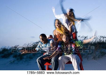 Hippies hanging out at the beach on lifeguard chair View Large Photo Image Stock Image - Hippies hanging out at the beach on lifeguard chair. Fotosearch