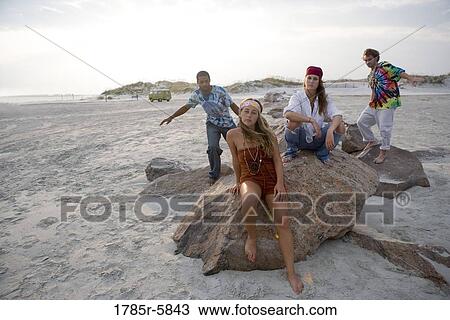 Hippies hanging out at the beach View Large Photo Image Stock Image - Hippies hanging out at the beach. Fotosearch