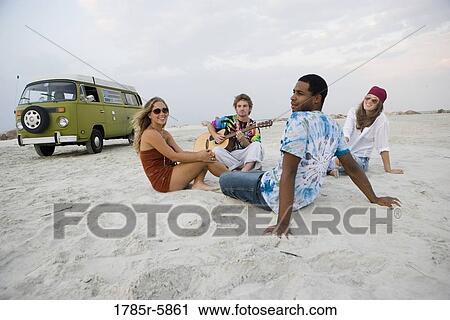 Hippies hanging out at the beach View Large Photo Image Stock Image - Hippies hanging out at the beach. Fotosearch
