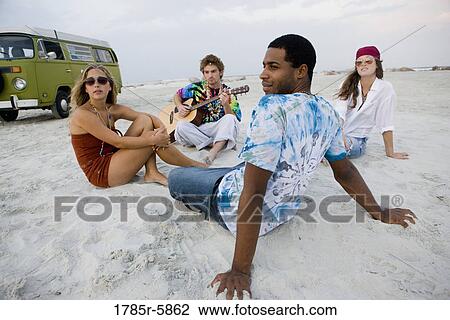 Hippies hanging out at the beach View Large Photo Image Stock Image - Hippies hanging out at the beach. Fotosearch
