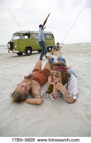 Hippies hanging out at the beach View Large Photo Image Stock Photo - Hippies hanging out at the beach. Fotosearch