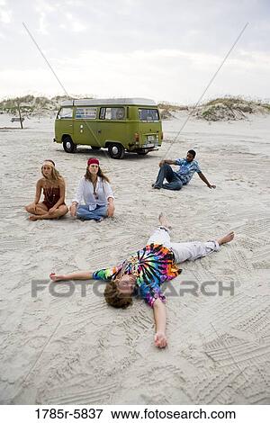 Hippies hanging out at the beach View Large Photo Image Stock Photo - Hippies hanging out at the beach. Fotosearch