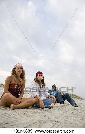 Stock Photo - Hippies hanging out at the beach. Fotosearch