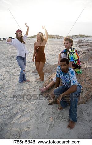 Stock Photo - Hippies hanging out at the beach. Fotosearch