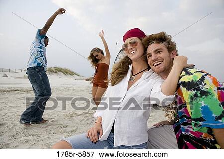 Stock Photo - Hippies hanging out at the beach. Fotosearch