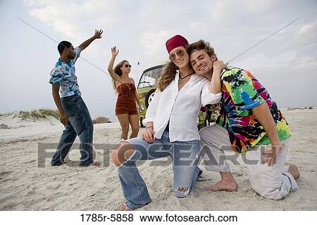 Stock Photo - Hippies hanging out at the beach. Fotosearch