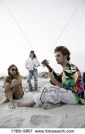 Hippies hanging out at the beach View Large Photo Image Stock Photo - Hippies hanging out at the beach. Fotosearch