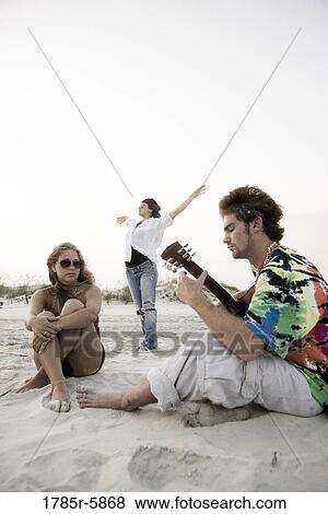 Hippies hanging out at the beach View Large Photo Image Stock Photo - Hippies hanging out at the beach. Fotosearch