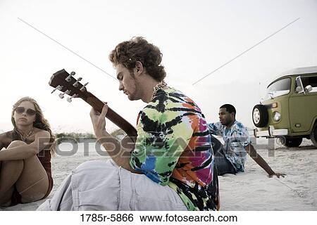 Hippies hanging out at the beach View Large Photo Image Stock Photograph - Hippies hanging out at the beach. Fotosearch