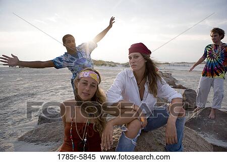 Stock Photography - Hippies hanging out at the beach. Fotosearch