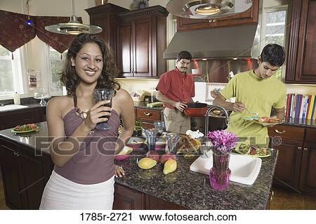 Indian family in kitchen preparing food View Large Photo Image Stock Image - Indian family in kitchen preparing food. Fotosearch