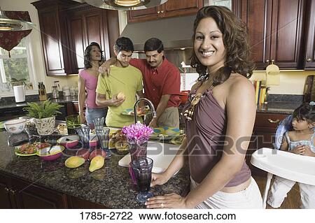 Indian family in kitchen preparing food View Large Photo Image Stock Image - Indian family in kitchen preparing food. Fotosearch