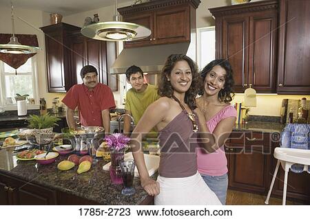 Indian family in kitchen preparing food View Large Photo Image Stock Image - Indian family in kitchen preparing food. Fotosearch
