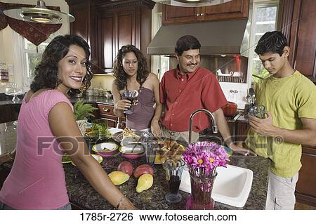 Indian family in kitchen preparing food View Large Photo Image Stock Photograph - Indian family in kitchen preparing food. Fotosearch