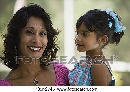 Stock Photography - Indian woman carrying little girl. Fotosearch
