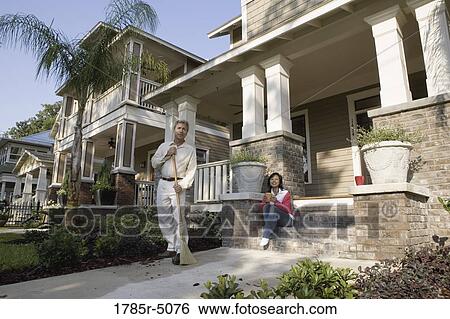 Interracial couple on front walkway of their house View Large Photo Image Stock Photograph - Interracial couple on front walkway of their house. Fotosearch