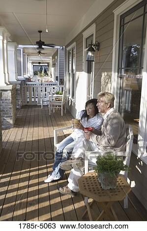 Interracial couple sitting on the front porch View Large Photo Image Stock Image - Interracial couple sitting on the front porch. Fotosearch