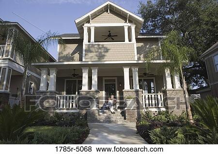 Interracial couple sitting on the front steps of their house View Large Photo Image Stock Photo - Interracial couple sitting on the front steps of their house. Fotosearch