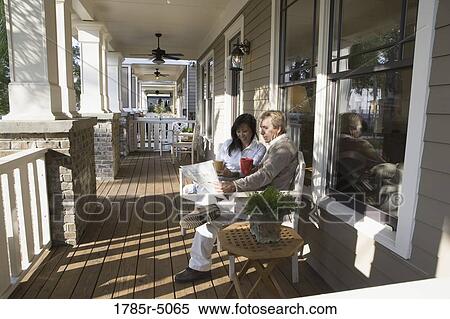 Interracial couple sitting on the front porch View Large Photo Image Stock Photography - Interracial couple sitting on the front porch. Fotosearch