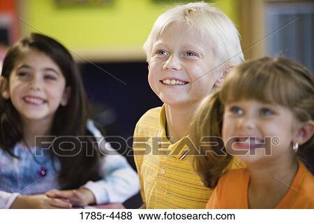 Kids posing and smiling together in a colorful classroom View Large Photo Image Stock Photo - Kids posing and smiling together in a colorful classroom. Fotosearch