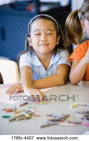 Little girl picking crayon with eyes closed View Large Photo Image Stock Photo - Little girl picking crayon with eyes closed. Fotosearch