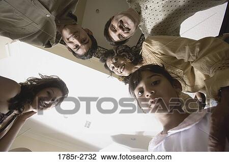 Low angle view of a family standing together View Large Photo Image Stock Image - Low angle view of a family standing together. Fotosearch