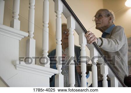 Stock Photography - Low angle view of a senior couple climbing up stairs. Fotosearch