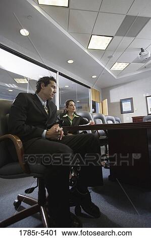 Low angle view of business man and woman meeting in a formal conference room View Large Photo Image Stock Image - Low angle view of business man and woman meeting in a formal conference room. Fotosearch