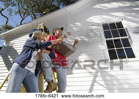 Low angle view of mature couple with ladder and painting tools preparing to paint outside of house View Large Photo Image Stock Image - Low angle view of mature couple with ladder and painting tools preparing to paint outside of house. Fotosearch