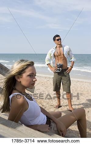 Picture - Man and woman relaxing at the beach. Fotosearch