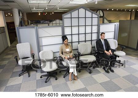 Man and woman sitting in an office waiting area View Large Photo Image Stock Image - Man and woman sitting in an office waiting area. Fotosearch