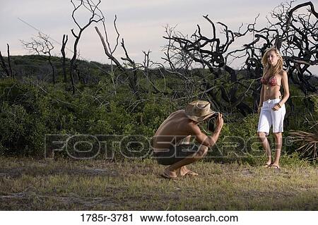 Man photographing a scantily clad woman View Large Photo Image Stock Image - Man photographing a scantily clad woman. Fotosearch