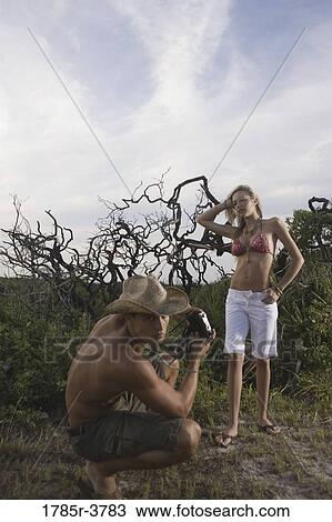 Man photographing a scantily clad woman View Large Photo Image Stock Image - Man photographing a scantily clad woman. Fotosearch